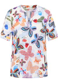 Kortermet bluse i let stof med et farverigt sommerfugl- og blomstermotiv, med V-udskæring og afslappet pasform.