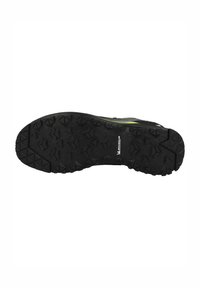 Suela de zapatilla deportiva negra con tacos de tracción profundos y multidireccionales. Presenta un borde suave y un logo de marca reconocible.