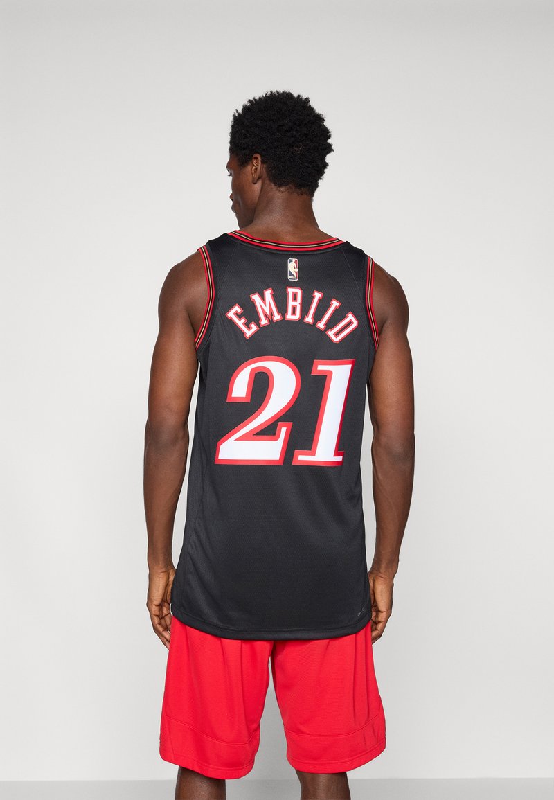 Black basketball jersey with red trim, featuring "EMBIID" and number "21" on the back. Paired with red athletic shorts.