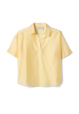 Kort mouwtjes, lichtgele blouse met open kraag en losse pasvorm, label "Stefanel" genaaid aan de binnenkant van de halslijn.
