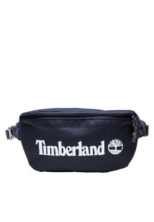 Granatowa nerka Timberland z dużym białym logo, zapięciem na zamek błyskawiczny i regulowanym bocznym paskiem.
