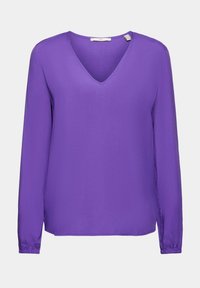 Blouse violette à manches longues avec un col en V. Confectionnée en tissu lisse, elle présente des poignets élastiqués et une coupe légèrement ample.