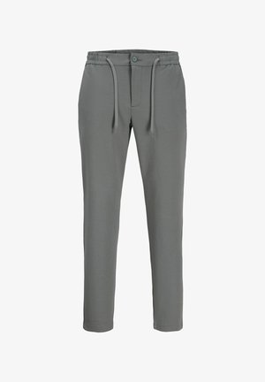 Pelēkas sporta bikses ar elastīgu jostu, aukliņu detaļām un pogas aizdari. Tām ir šaurāk piegulošas kājas un mīksta tekstūra.