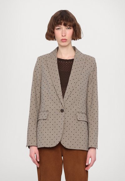 Beige ternet blazer med blå og sorte prikker, med notched lapels, to lommer og lukning med en enkelt knap. Tekstureret stof.
