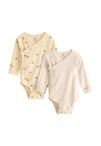 Dwa body niemowlęce z długim rękawem. Jedno jest jasnożółte w brązowe kropki; drugie jest w jednolitym jasnym kremowym kolorze. Oba mają zatrzaski na dole.