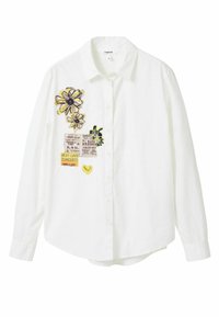 Bílá košile na knoflíky s vyšívanými květinami ve žluté a černé barvě, doplněná potiskem a žlutým detailem ve tvaru srdce.