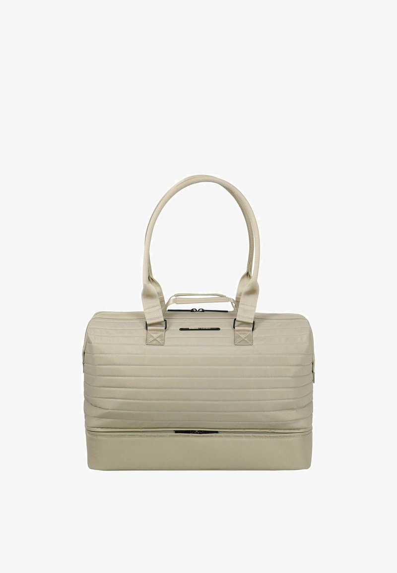 Sac de voyage matelassé beige avec deux poignées, une fermeture éclair sur le dessus et un compartiment inférieur séparé avec fermeture éclair.