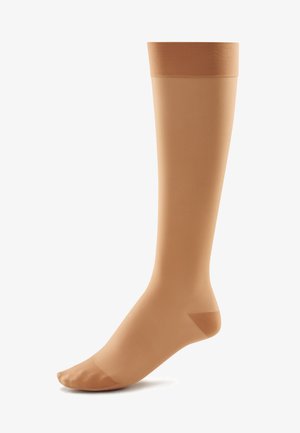 Kompressionskniestrümpfe in sanftem Beige, mit glatter Textur, verstärkter Fußspitze und einem engen Elastikband oben.