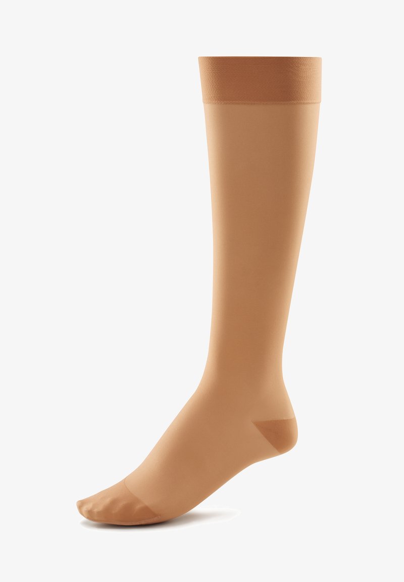 Compression knee-high stockings in soft beige, featuring a smooth texture, reinforced toe, and a snug elastic band at the top.
