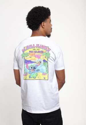 White short-sleeve t-shirt featuring a colorful graphic on the back, depicting a cartoon character and tropical scene with palm trees.