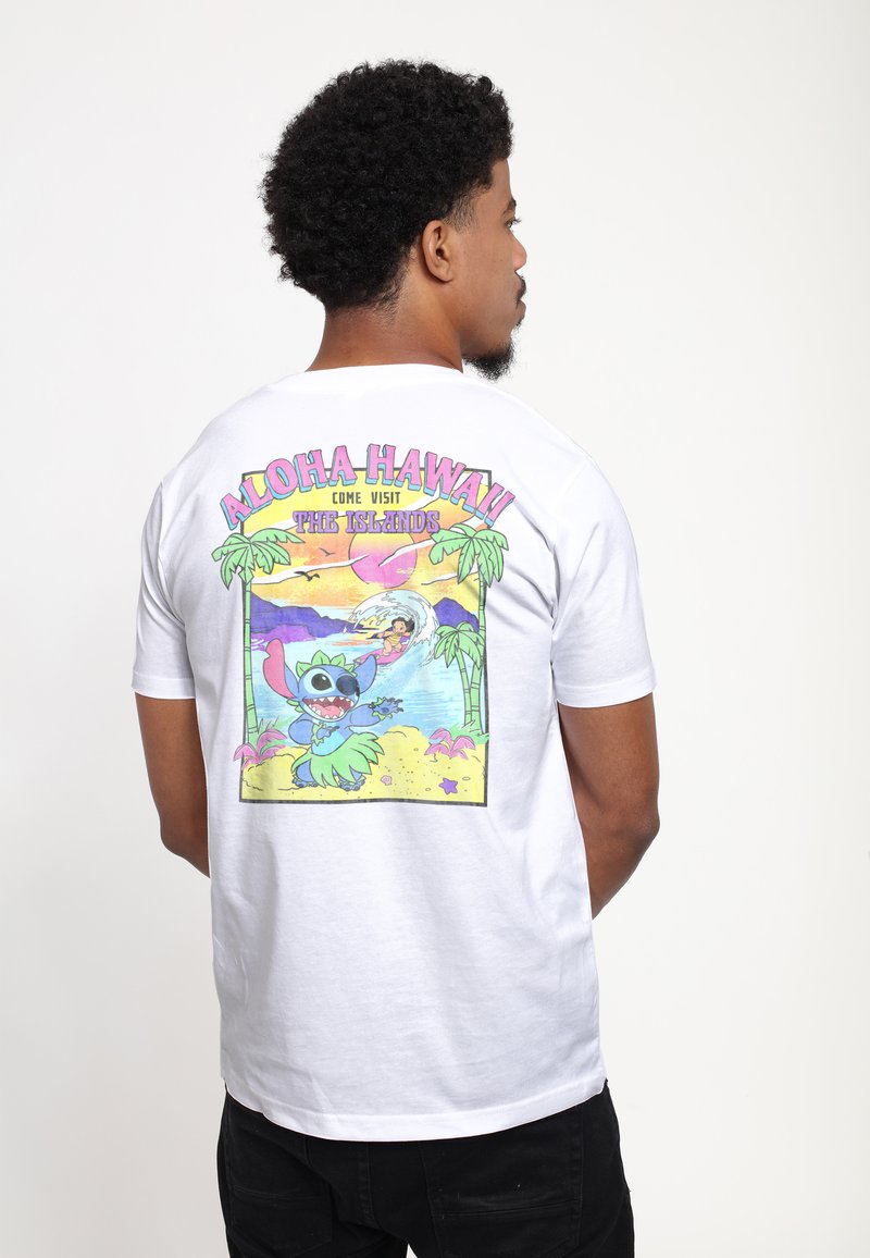 White short-sleeve t-shirt featuring a colorful graphic on the back, depicting a cartoon character and tropical scene with palm trees.