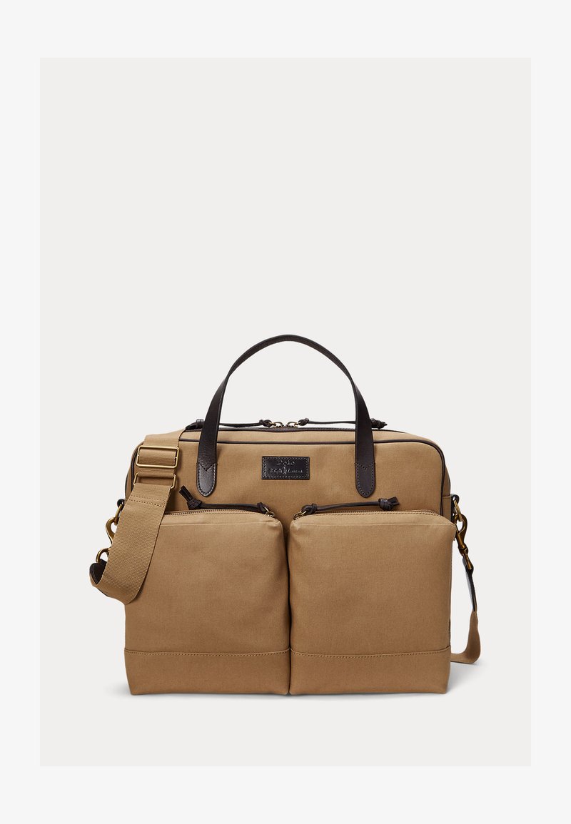 Tan canvas briefcase with two front zippered pockets, dark brown leather handles, and an adjustable shoulder strap with brass hardware.