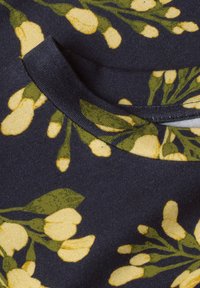 Navy fabric with green stems and yellow floral buds printed around a rounded neckline seam.