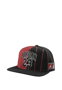 Cappellino da baseball nero e rosso con strisce verticali, recante la scritta "JORDAN 23" ricamata in bianco e una toppa con logo sul lato.