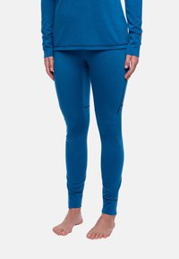 Haut à manches longues bleu et leggings assortis en tissu lisse et extensible. Les leggings disposent de poches latérales et de poignets ajustés aux chevilles.