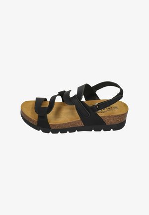 Schwarze Sandalen mit mehreren Riemen, einer Kork-Zwischensohle und einer strukturierten Sohle. Die Fußbett ist braun mit einem leichten Bogen zur Unterstützung.