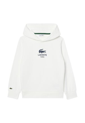 Haut à capuche blanc en tissu doux avec une poche kangourou. Présente un logo Lacoste bleu marine et un petit emblème de crocodile vert sur la manche.