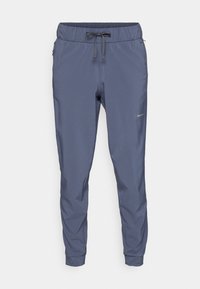 Men's jogger pants in dark blue, made of lightweight fabric. Features elastic waistband with drawstring and zipper pockets on both sides.