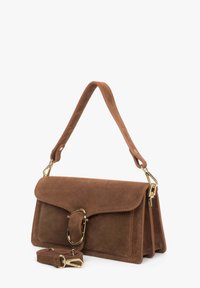 Bruine suède handtas met een gestructureerde vorm, voorzien van een gouden sluiting en een verstelbare schouderband. Gladde textuur met strakke lijnen.