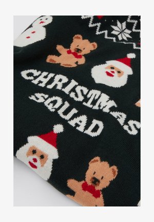 Jersey de punto con fondo verde oscuro y patrones de Papá Noel, muñeco de nieve y oso de peluche. El texto dice "CHRISTMAS SQUAD" en blanco.