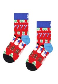 Chaussettes rouges ornées de bonhommes de neige, de bonhommes en pain d'épices, de cannes en bonbon et de sapins de Noël. Accents bleus et zone des orteils noire. Texte indiquant "JOYEUX."
