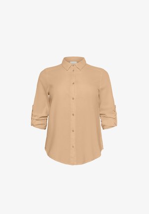 Vaaleanbeige napillinen paita, jossa on kaulus, pitkät hihat käännettynä kyynärpäihin ja sileä pinta. Sisältää suoran leikkauksen helman.