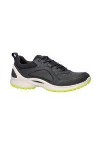 Scarpa sportiva grigio scuro con colletto in rete nera, suola intermedia bianca, suola esterna verde neon e lacci neri su sfondo bianco.