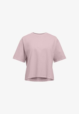 T-shirt ample à manches courtes rose clair avec un col rond et un ourlet légèrement arrondi sur fond blanc.