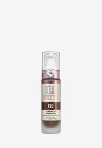 Foundation i en klar cylindrisk flaska med en vit pump. Etiketten har texten "IRL FILTER F20" och visar rosa och beige nyanser med textdetaljer.