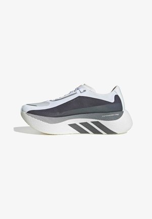 Zapatilla de running moderna blanca y negra con suela gruesa, parte superior de malla y tres rayas negras en el lateral sobre un fondo blanco.