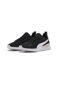 Chaussures de sport noires avec tige en mesh, semelle intermédiaire blanche, accents roses et design à lacets ; elles sont dotées d'une semelle amortissante et d'un col rembourré.