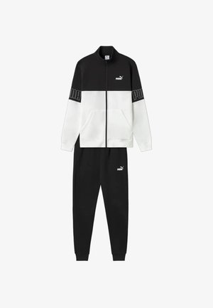 Tuta Puma in bianco e nero con giacca con zip e logo sul petto e sulle maniche, e pantaloni jogger neri abbinati con logo sulla coscia.