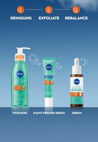 Three skincare products displayed on a gradient blue background: a green gel cleanser, a teal exfoliating serum in a tube, and a brown dropper serum.