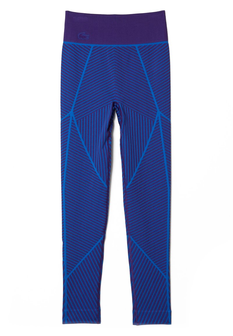Fioletowe legginsy z geometrycznym wzorem w niebieskim, z ukośnymi paskami. Wykonane z elastycznego materiału, zaprojektowane z myślą o wygodzie i swobodzie ruchów.