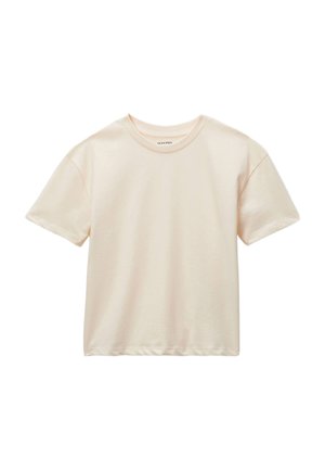 T-shirt en coton beige clair avec un col rond, des manches courtes et une coupe décontractée. Texture lisse avec des détails de couture minimaux.