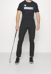 Nike Golf Triko s potiskem - black
