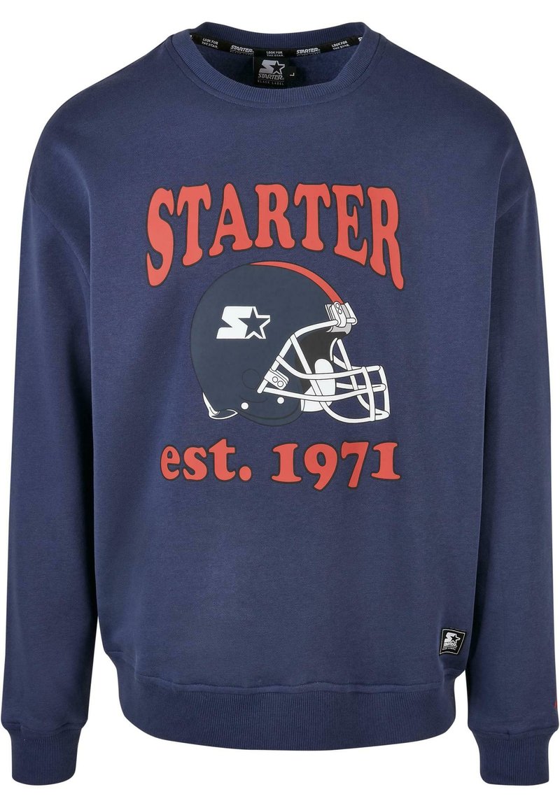Sötétkék pulóver, nagy piros "STARTER" logóval és egy fehér amerikai futball sisak grafikával, alatta az "est. 1971" felirattal. Puha anyagból készült, bordázott mandzsettákkal.