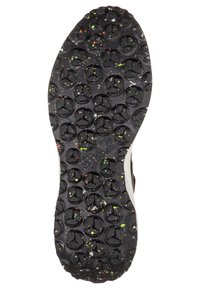 Sole di scarpa nera con un motivo di battistrada rotondo a tre punte e macchie multicolori di verde, arancione e bianco.
