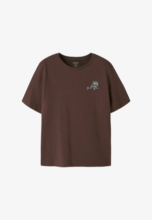 Brown short-sleeve t-shirt with small light blue palm tree graphic and "Hotel De Jardins Antigua" text on left chest.
