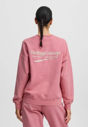 Rosa Sweatshirt mit gerippten Bündchen und Saum. Auf der Rückseite befindet sich das Logo "TheJoggConcept SPORT SERVICE" in einer kontrastierenden hellen Farbe.