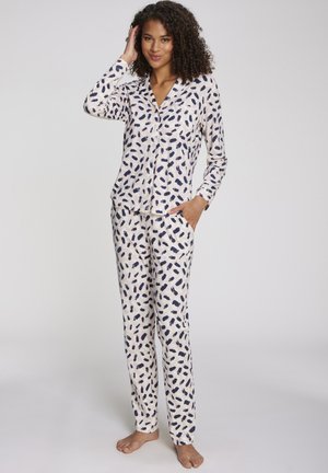 Langärmliges Pyjama-Set aus weichem, leichtem Stoff mit einem cremefarbenen Hintergrund, der ein dunkelblaues abstraktes Muster und zwei Taschen zeigt.