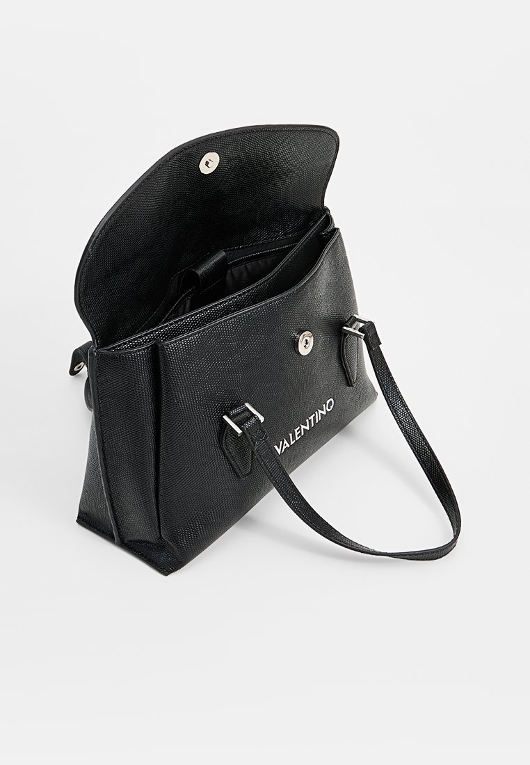 Sac à main en cuir noir avec une finition texturée, fermeture par rabat supérieur et quincaillerie en tonalité argentée. Comprend une bandoulière ajustable et une poche intérieure.