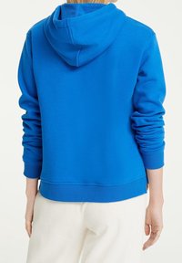 Bright blue hoodie with a soft texture, featuring a drawstring hood, ribbed cuffs, and a wide hem. The back is smooth, showcasing a casual design.