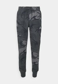 Kamouflage joggerbyxor i mörkgrå nyanser, tillverkade av mjukt tyg, med elastisk midja med snöre och ribbade muddar.