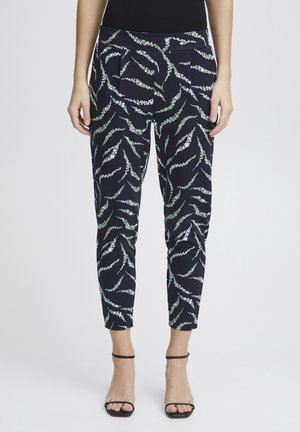 Pantaloni blu navy con un motivo floreale verde e bianco, caratterizzati da una vestibilità aderente e lunghezza alla caviglia, realizzati in tessuto morbido e elasticizzato.