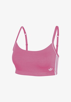 Różowy sportowy braletka wykonany z miękkiego materiału, z cienkimi regulowanymi ramiączkami i białymi paskami po bokach. Małe logo na dolnym lewym rogu.