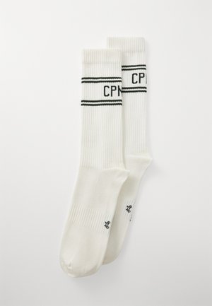 White ribbed socks featuring two black horizontal stripes and "CPH" text on the upper band, with a small logo on the sole section.