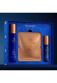 Blue gift box featuring three products: a dark blue cleansing gel, an orange eye patch package, and a dark blue hydrating cream, all with gold accents.