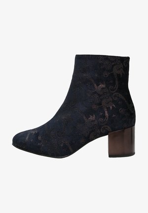 Ankle boot in dark navy fabric with a floral pattern, featuring a chunky metallic heel and a pointed toe design.