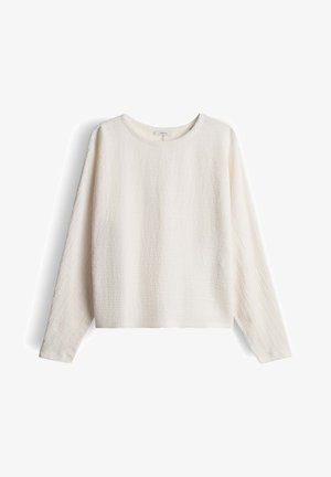 Pullover a maniche lunghe color crema chiaro, tessuto strutturato con un motivo sottile, scollo rotondo e vestibilità rilassata. Stile morbido e casual.